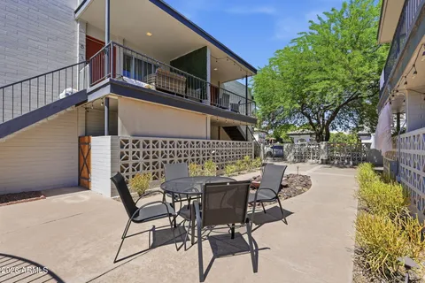 a view of a house with backyard and sitting area