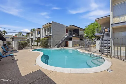 a view of a swimming pool with outdoor seating