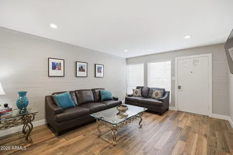 a living room with furniture and a wooden floor