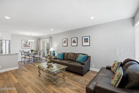 a living room with furniture rug and wooden floor