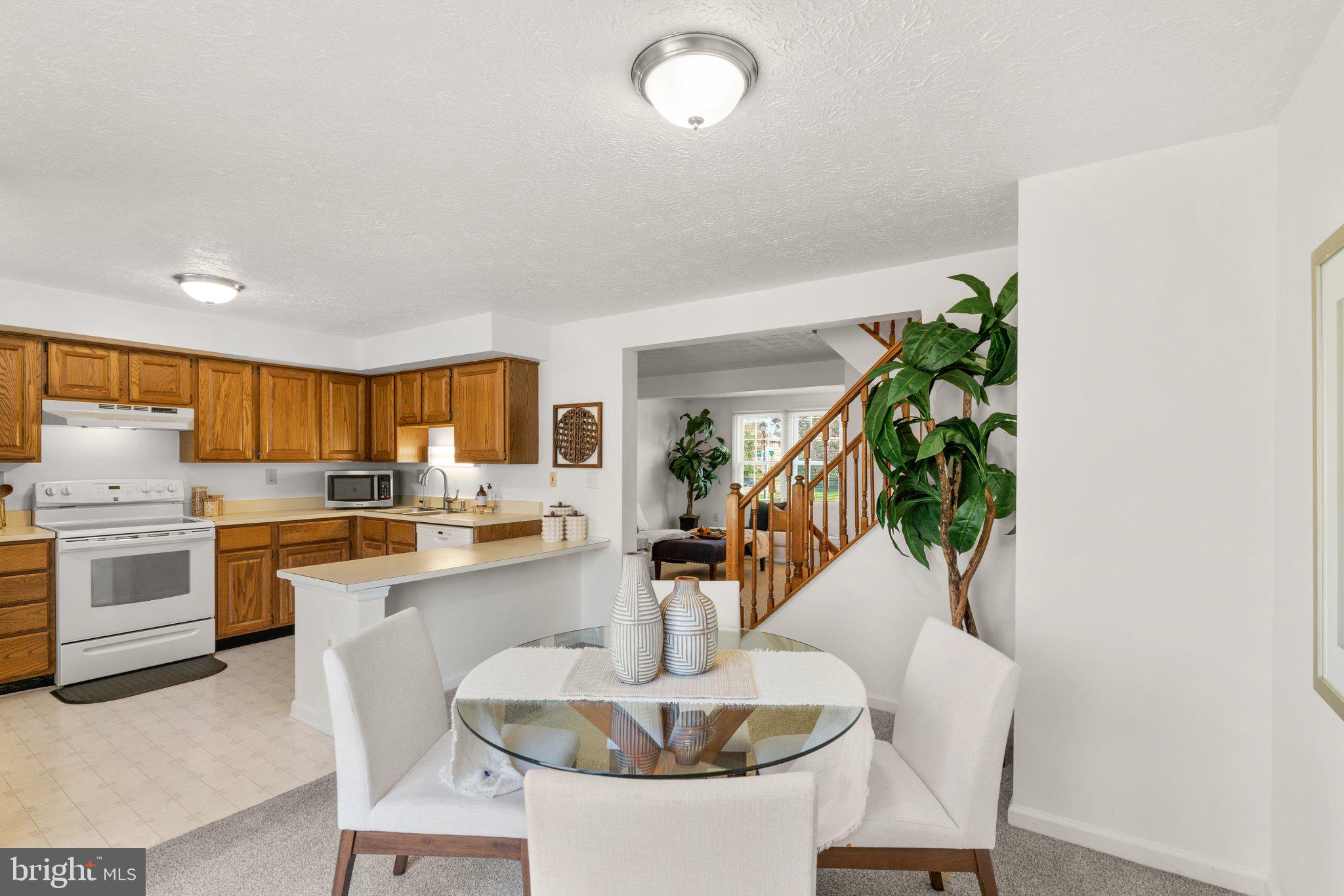 2 Ramsgate Court Halethorpe, MD 21227 - Photo 6 of 30 a kitchen with granite countertop white cabinets and white appliances