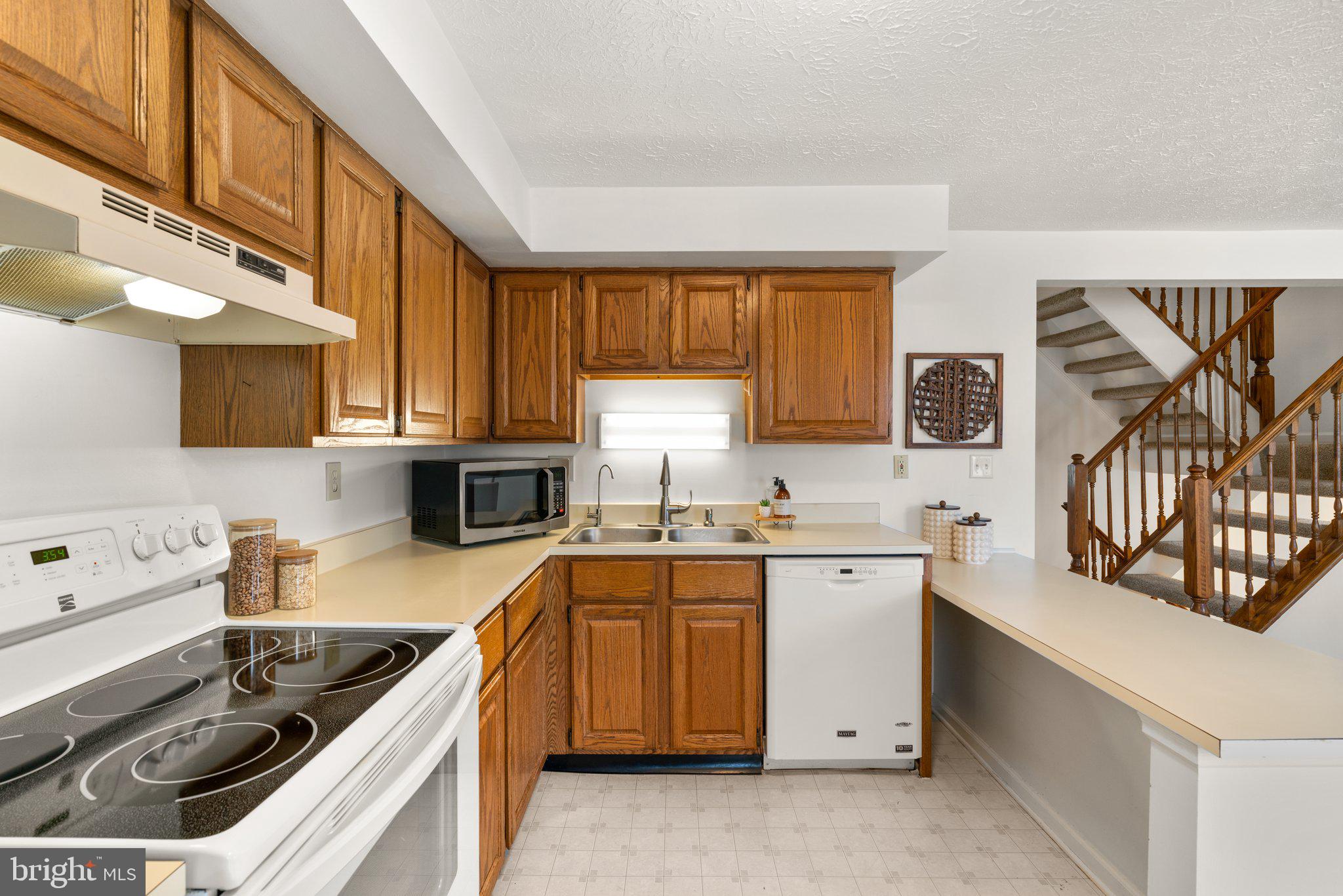 2 Ramsgate Court Halethorpe, MD 21227 - Photo 7 of 30 a kitchen with a sink stove top oven and cabinets