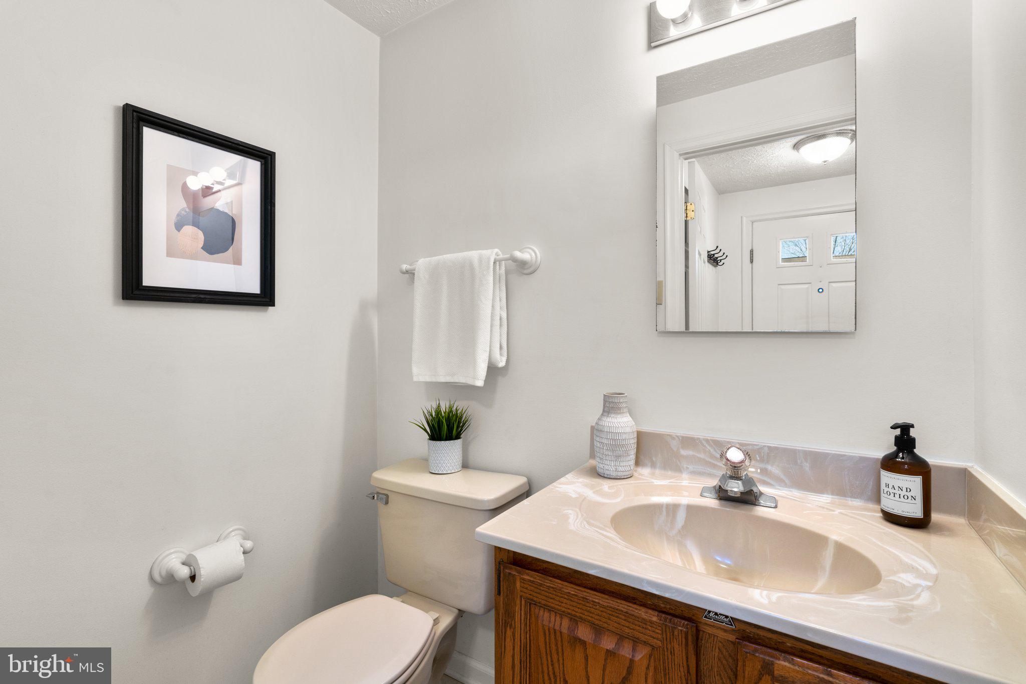 2 Ramsgate Court Halethorpe, MD 21227 - Photo 10 of 30 a bathroom with a toilet sink and mirror