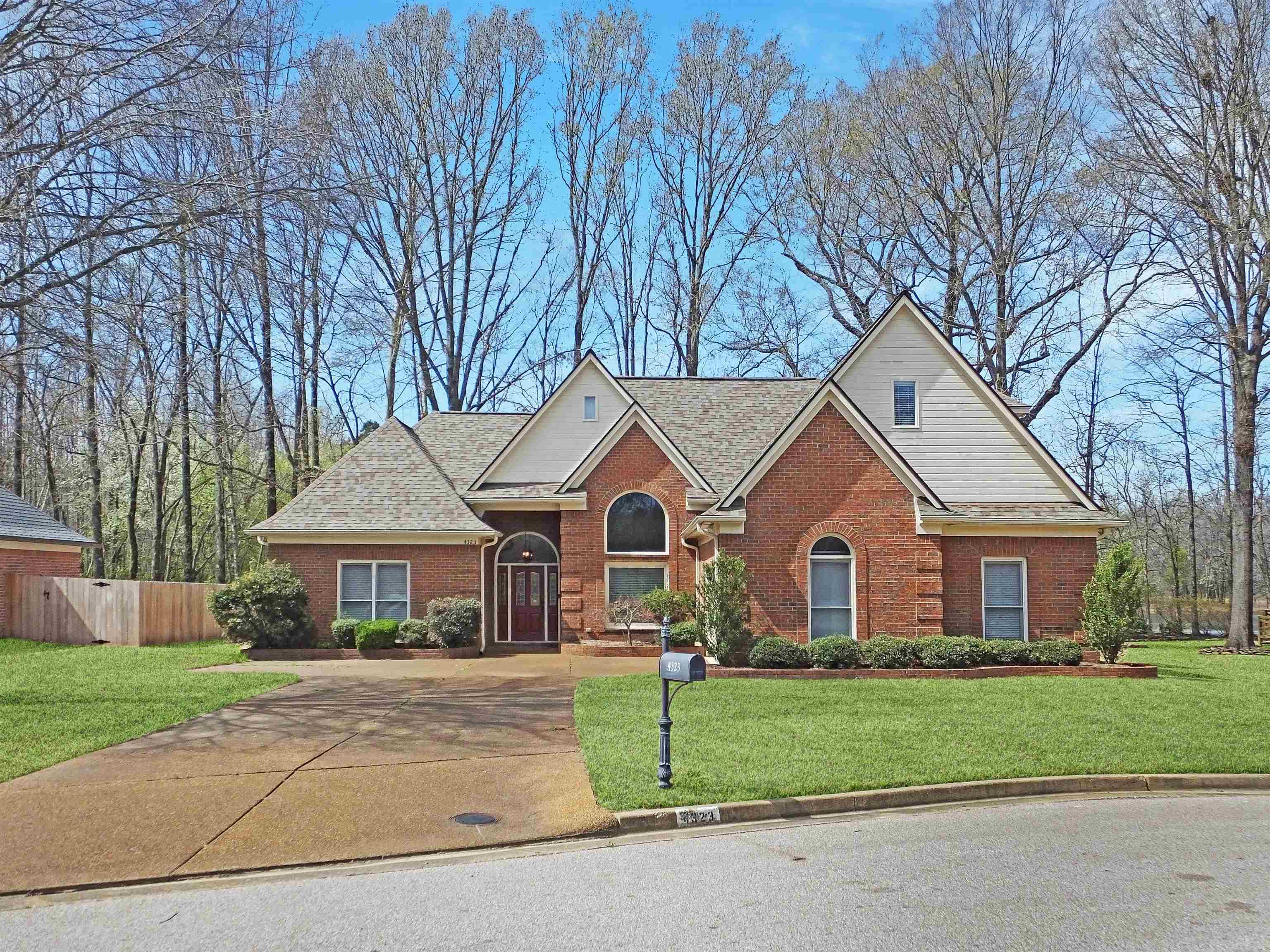 4323 Country Bridge Road Lakeland, TN 38002 - Photo 2 of 35 View of front of property featuring brick siding, a front yard, and fence