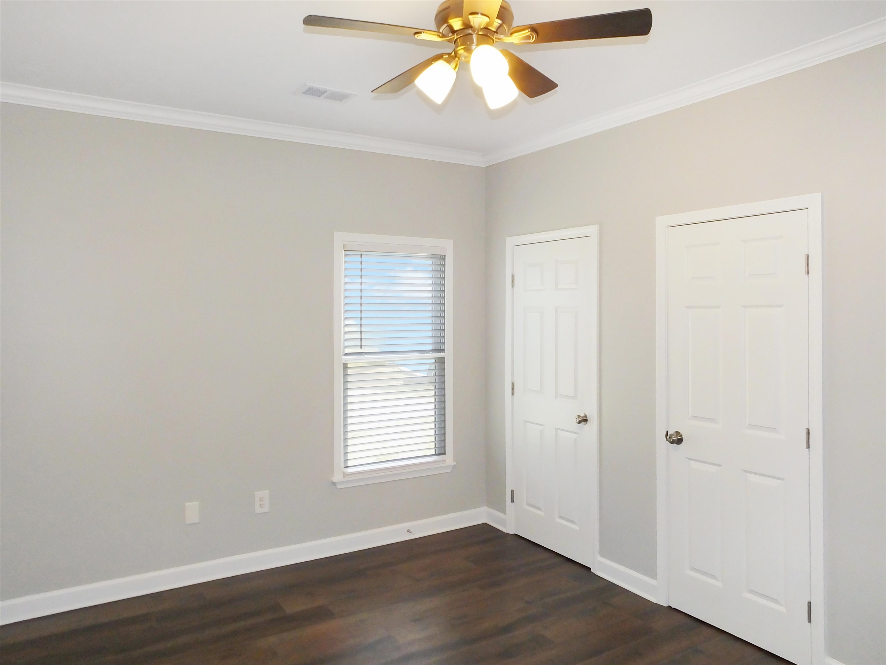 4323 Country Bridge Road Lakeland, TN 38002 - Photo 28 of 35 Unfurnished bedroom featuring visible vents, baseboards, dark wood-style floors, and ornamental molding