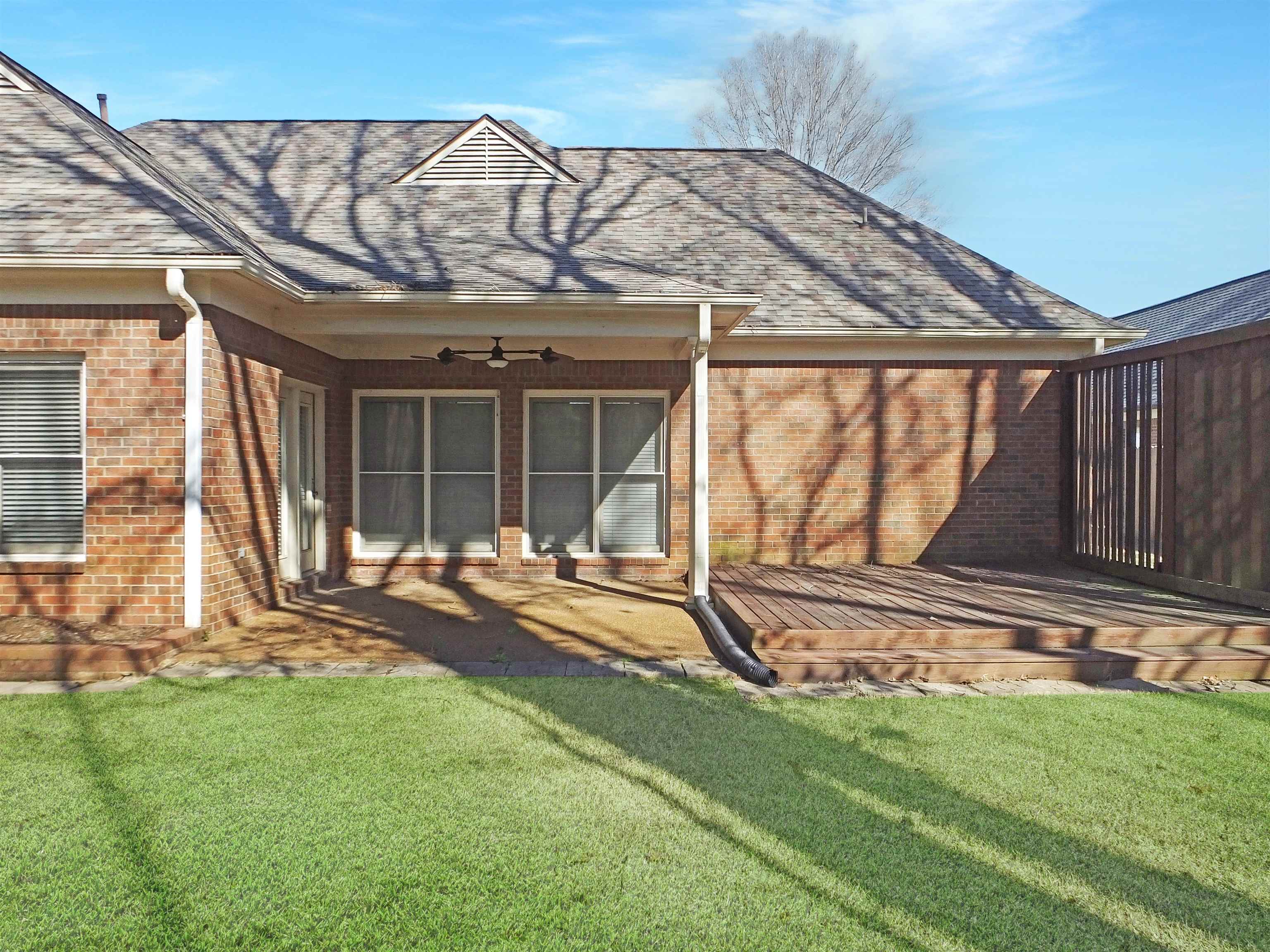 4323 Country Bridge Road Lakeland, TN 38002 - Photo 3 of 35 Rear view of house featuring a yard, brick siding, and a ceiling fan