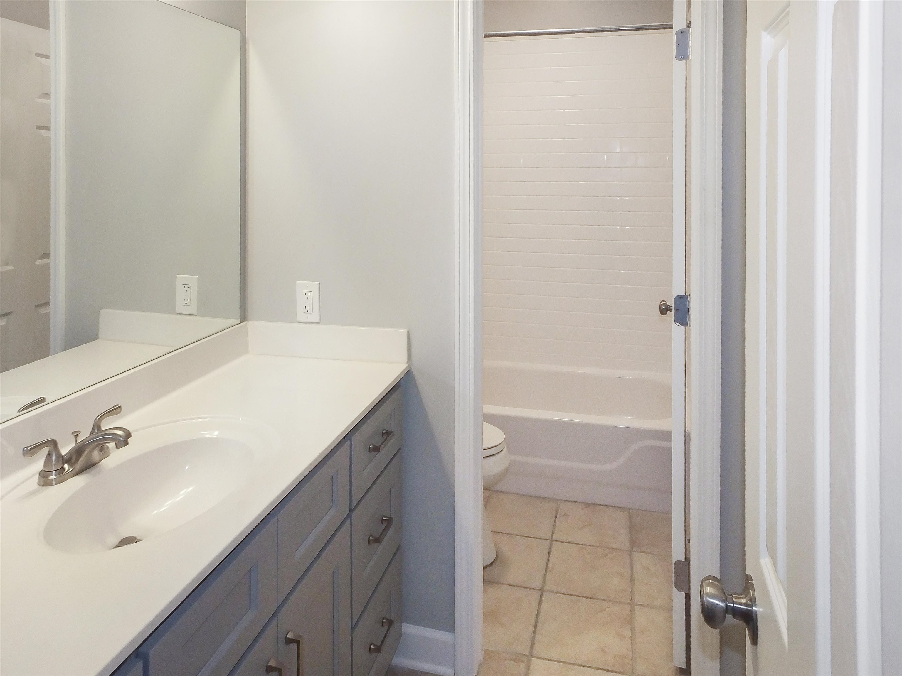 4323 Country Bridge Road Lakeland, TN 38002 - Photo 33 of 35 Bathroom featuring toilet, shower / tub combination, vanity, and tile patterned flooring