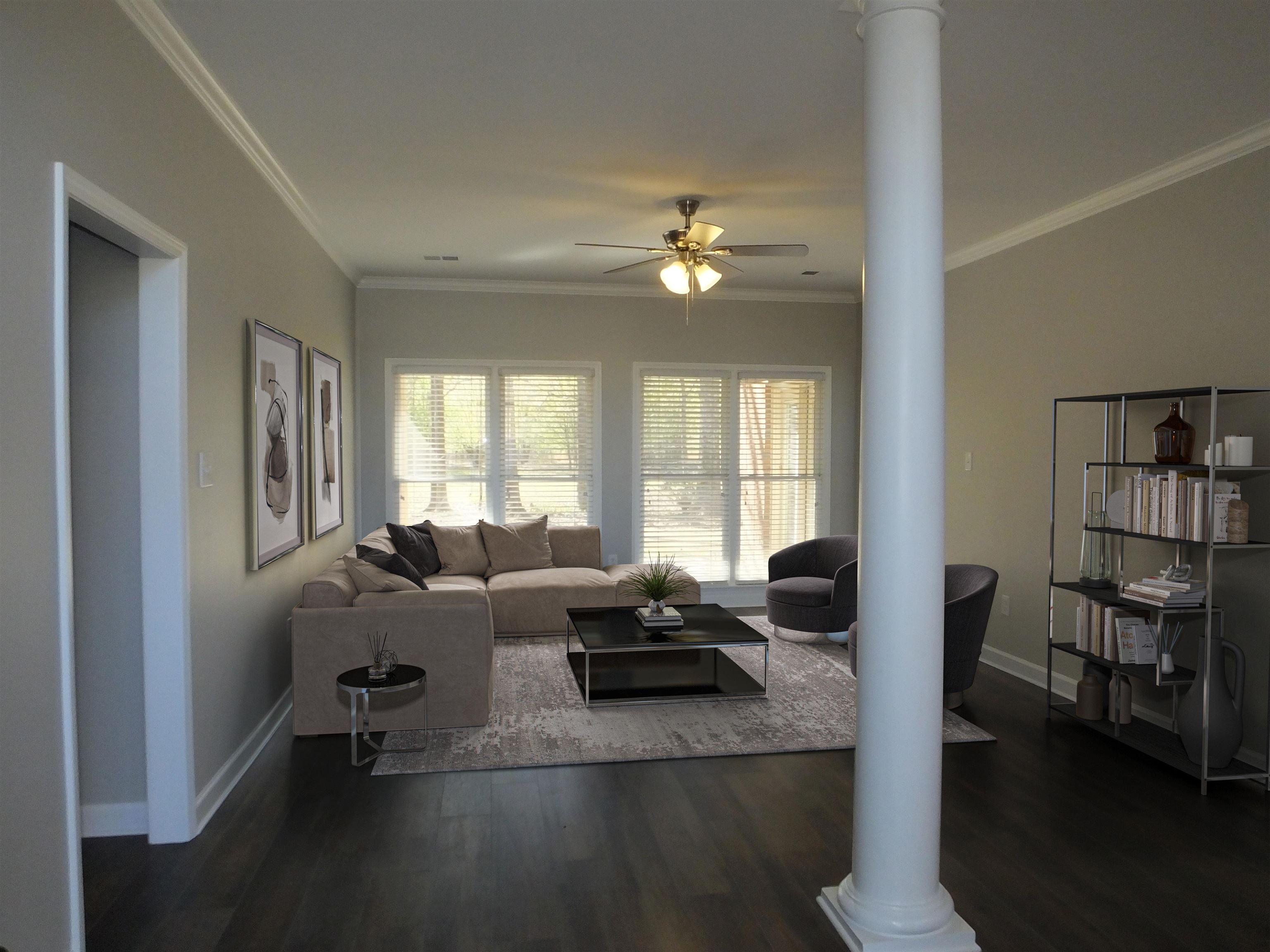 4323 Country Bridge Road Lakeland, TN 38002 - Photo 8 of 35 Living room with decorative columns, a ceiling fan, wood finished floors, baseboards, and ornamental molding