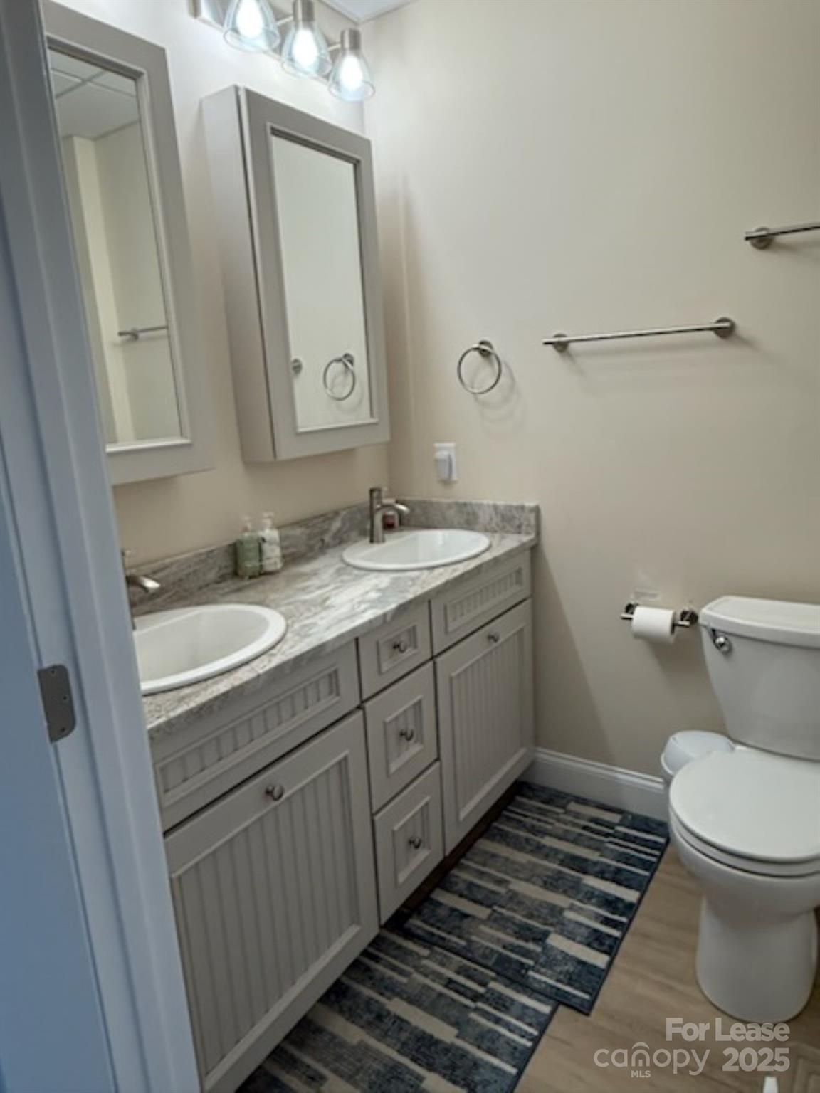 4897 Kiser Island Road, Unit A Terrell, NC 28682 - Photo 16 of 25 a bathroom with a granite countertop toilet sink and mirror