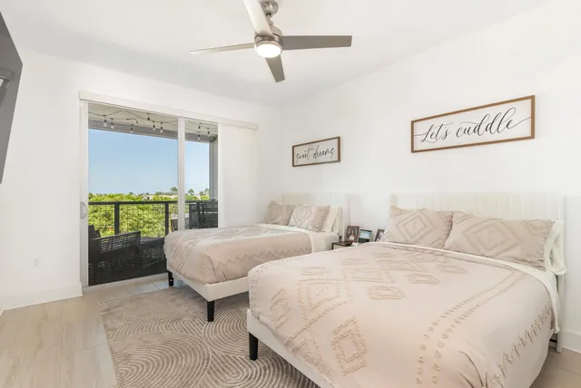 a bedroom with two beds and a chandelier