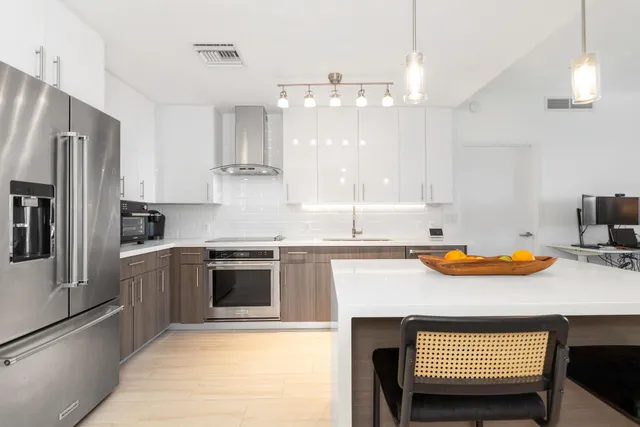 a kitchen with stainless steel appliances granite countertop a sink stove and refrigerator