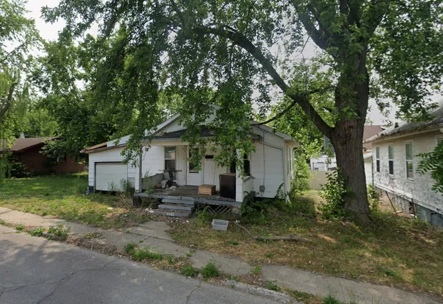 a house view with a sitting space and garden