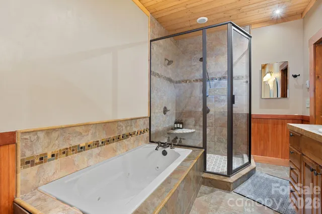 a bathroom with a tub sink and mirror