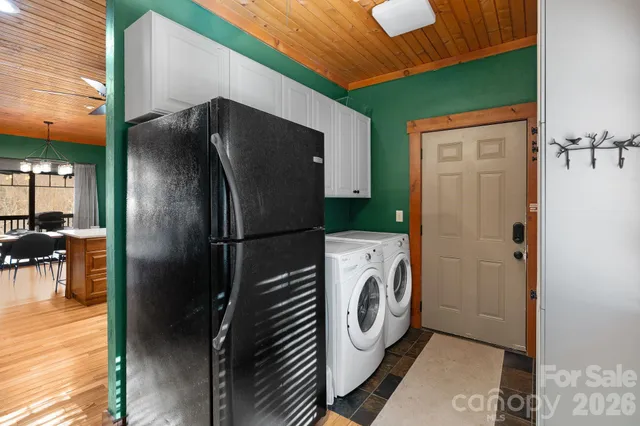 a living room with furniture flat screen tv and a table