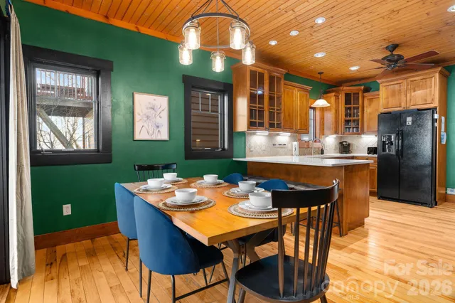 a kitchen with stainless steel appliances granite countertop a refrigerator a sink a stove and island