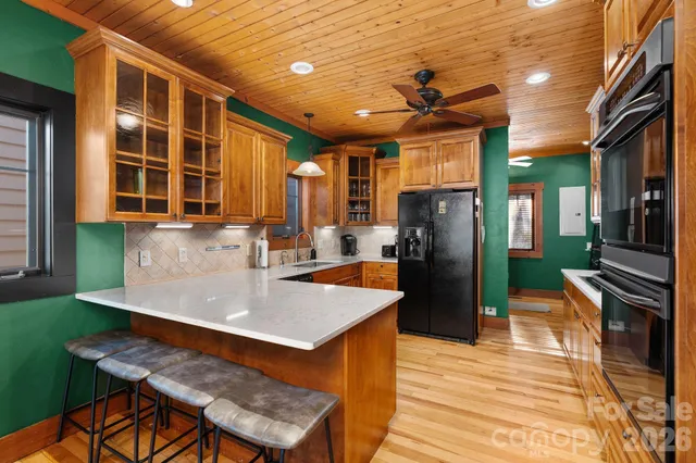 a kitchen with stainless steel appliances kitchen island granite countertop a stove and a refrigerator