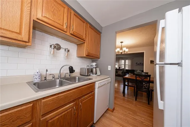 a kitchen with stainless steel appliances granite countertop a sink stove and cabinets