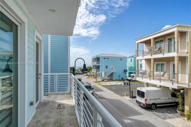 a view of a balcony with two chairs and a table