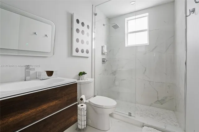 a bathroom with a toilet a sink and shower