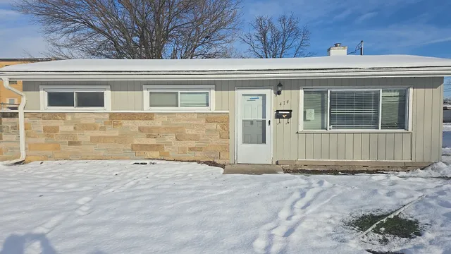 a view of a house with a wooden fence