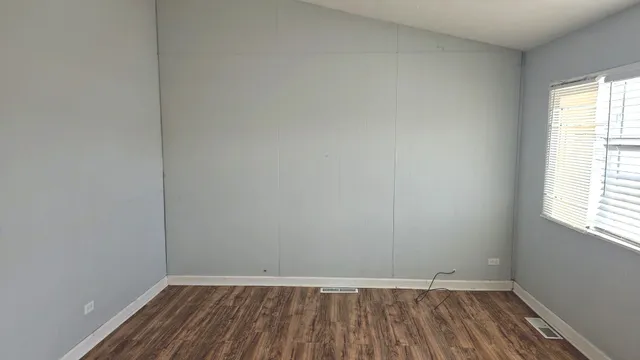 a view of a bedroom with wooden floor and bedroom