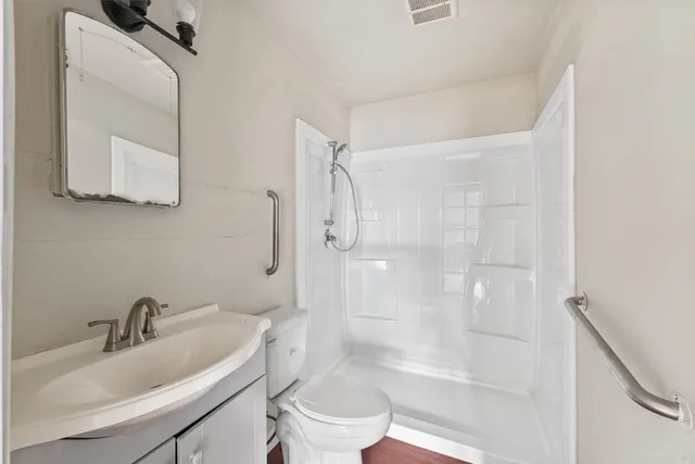 an empty room with windows and closet