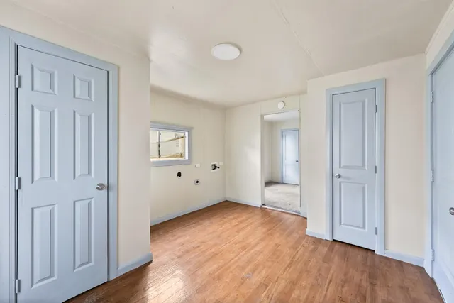 an empty room with windows and closet