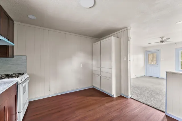 a view of a kitchen with wooden floor and electronic appliances