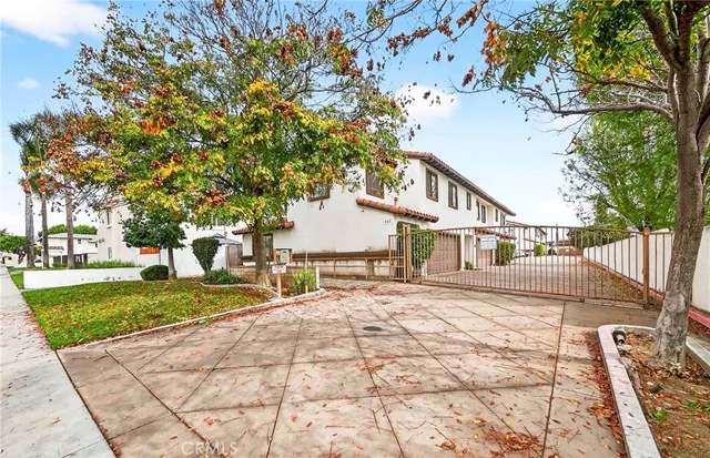 a view of a white house with a yard