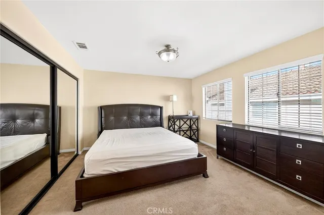 a bedroom with a large bed and a large window
