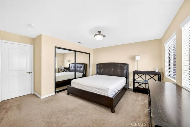 a bedroom with a bed and window