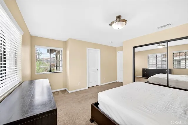 a bedroom with a large bed and a large window