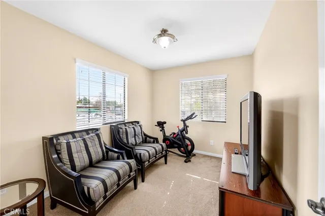a living room with furniture a large window and a flat screen tv