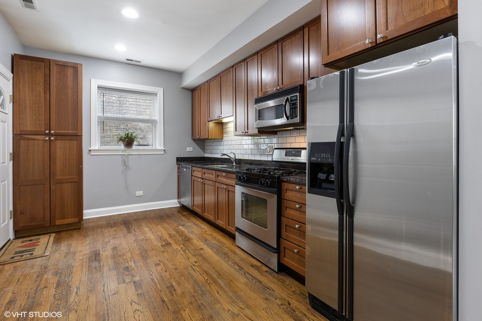 3522 North Racine Avenue, Unit 1N Chicago, IL 60657 - Photo 6 of 17 a kitchen with stainless steel appliances granite countertop a refrigerator a sink and a stove