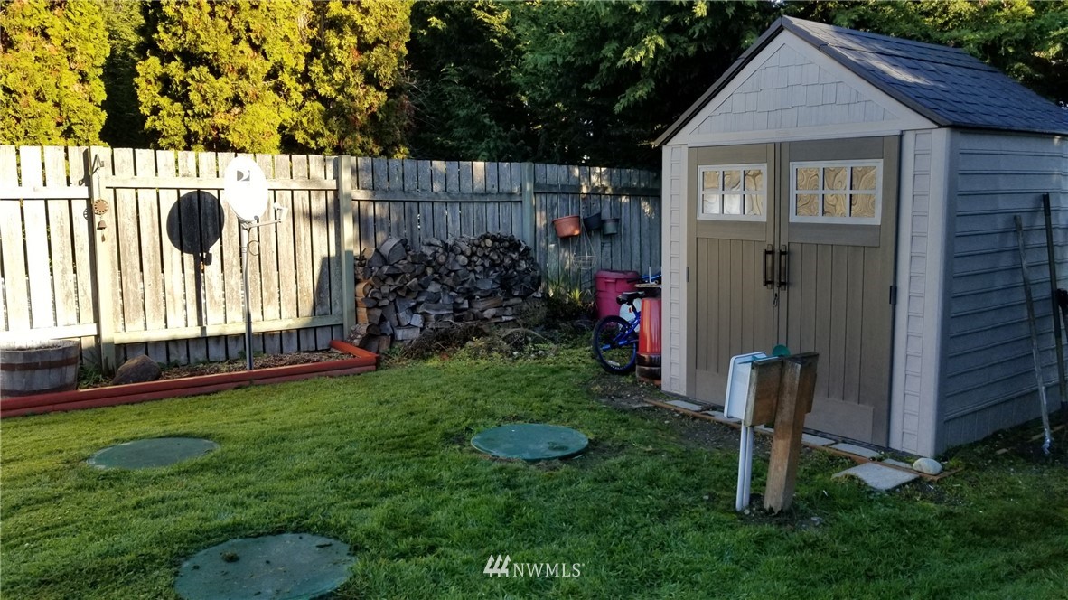 171 Spath Road Sequim, WA 98382 - Photo 19 of 21 a view of a house with a backyard and garden