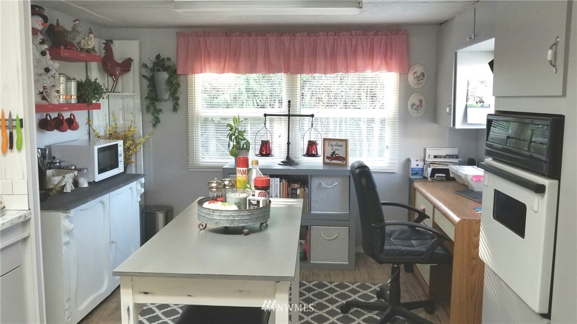 171 Spath Road Sequim, WA 98382 - Photo 7 of 21 a kitchen with a stove a sink and a refrigerator