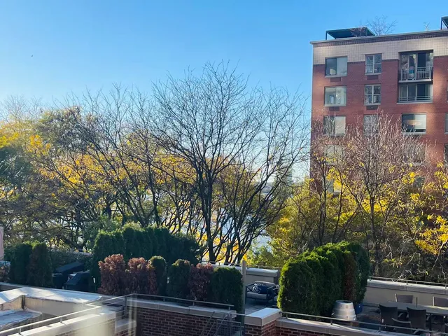 a view of a brick building next to a road