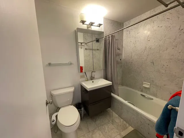 a bathroom with a sink toilet and shower