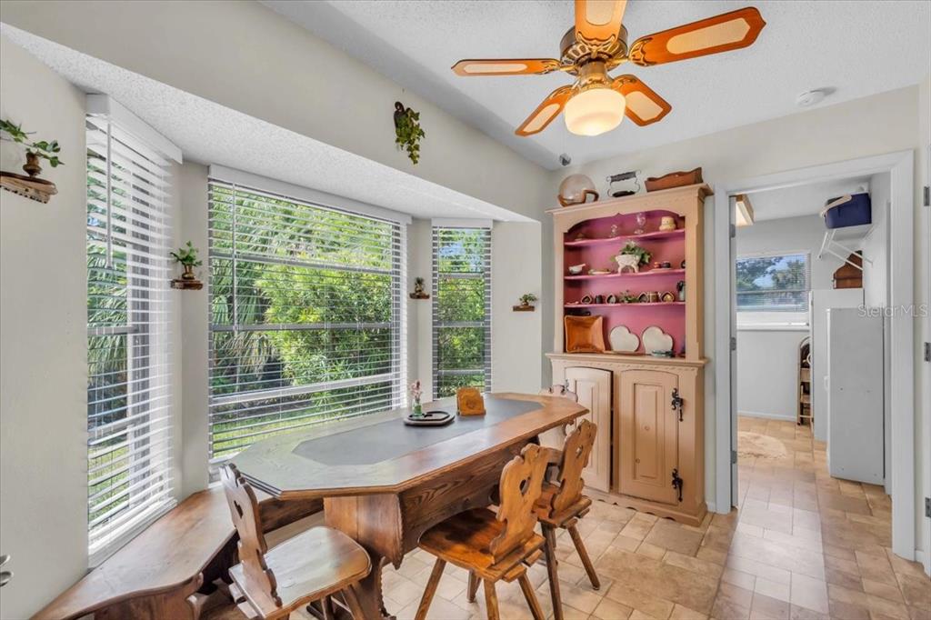 331 Burke Road Venice, FL 34293 - Photo 12 of 29 a view of a dining room with furniture window and wooden floor