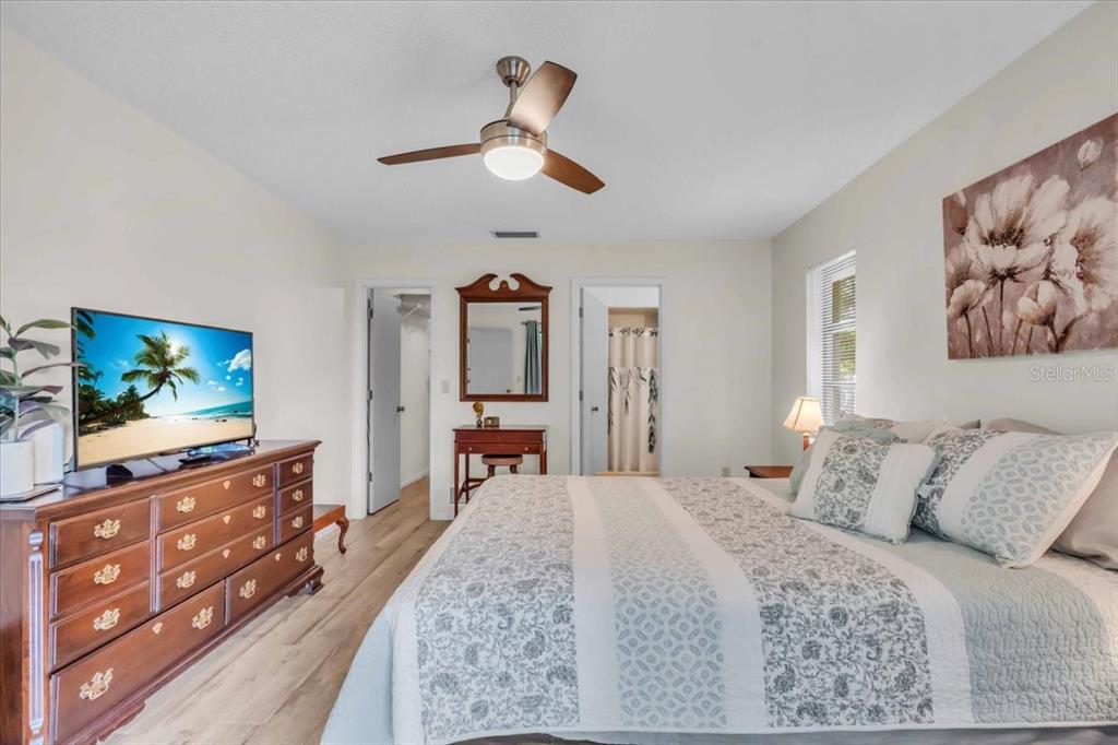 331 Burke Road Venice, FL 34293 - Photo 15 of 29 a bedroom with a bed and a flat screen tv