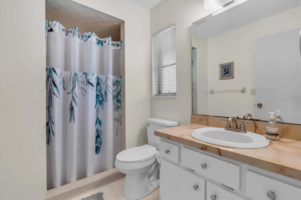 331 Burke Road Venice, FL 34293 - Photo 17 of 29 a bathroom with a granite countertop sink toilet and shower