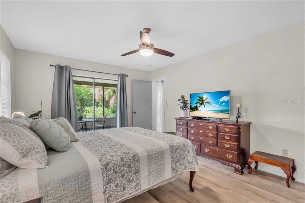 331 Burke Road Venice, FL 34293 - Photo 18 of 29 a bedroom with a bed a chandelier and a window