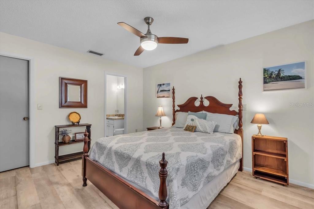 331 Burke Road Venice, FL 34293 - Photo 20 of 29 a bedroom with a bed and wooden floor