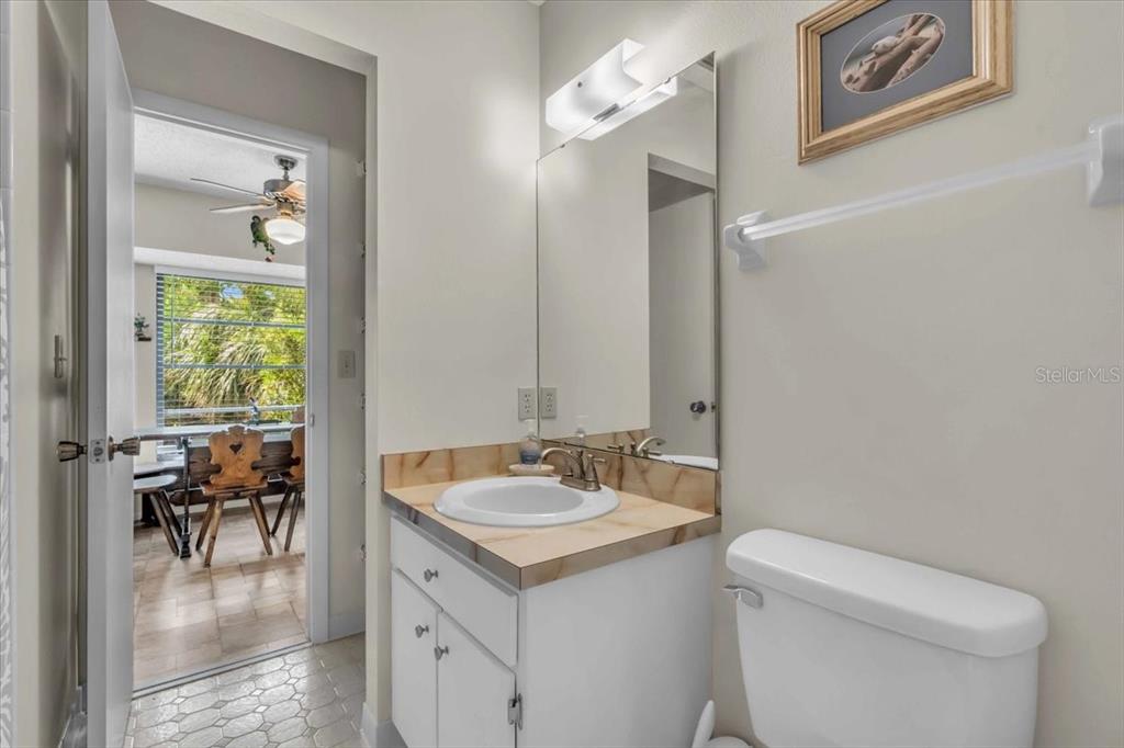 331 Burke Road Venice, FL 34293 - Photo 22 of 29 a bathroom with a toilet a sink a mirror and a shower