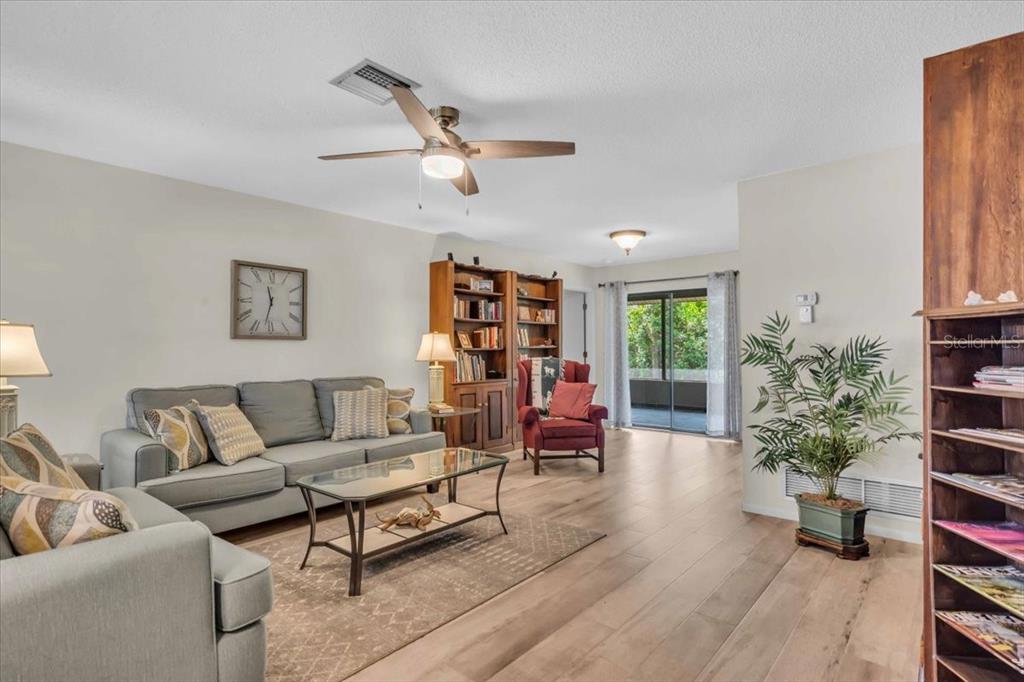 331 Burke Road Venice, FL 34293 - Photo 5 of 29 a living room with furniture and a potted plant
