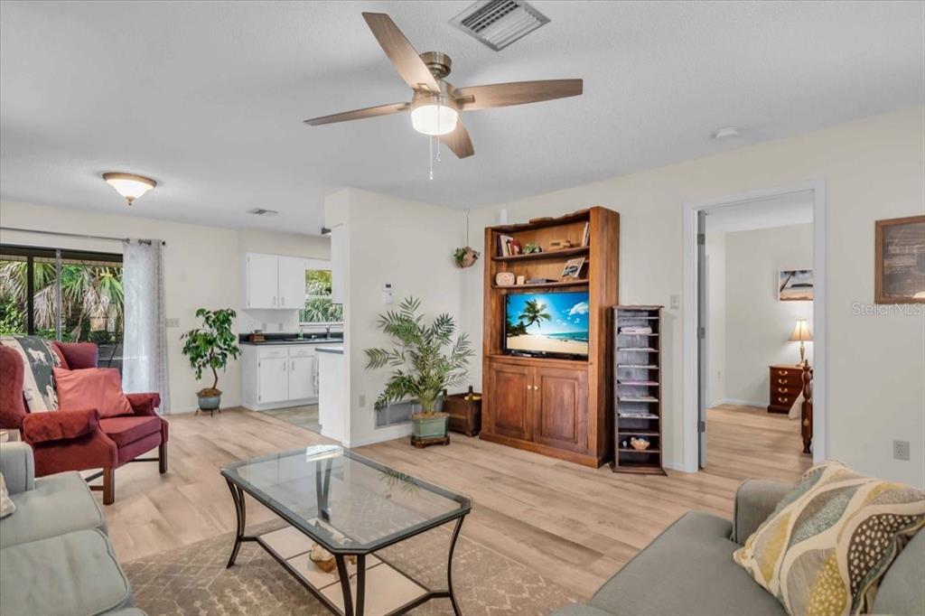 331 Burke Road Venice, FL 34293 - Photo 7 of 29 a living room with furniture a window and a flat screen tv