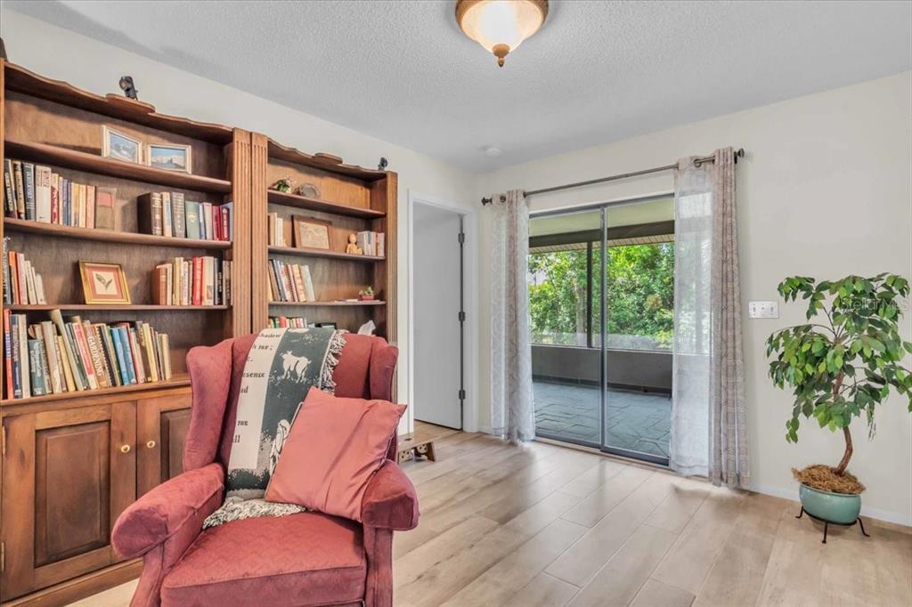 331 Burke Road Venice, FL 34293 - Photo 8 of 29 a living room with furniture and a book shelf