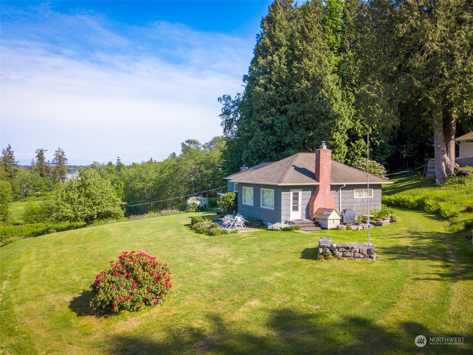 a view of a house with yard and sitting area
