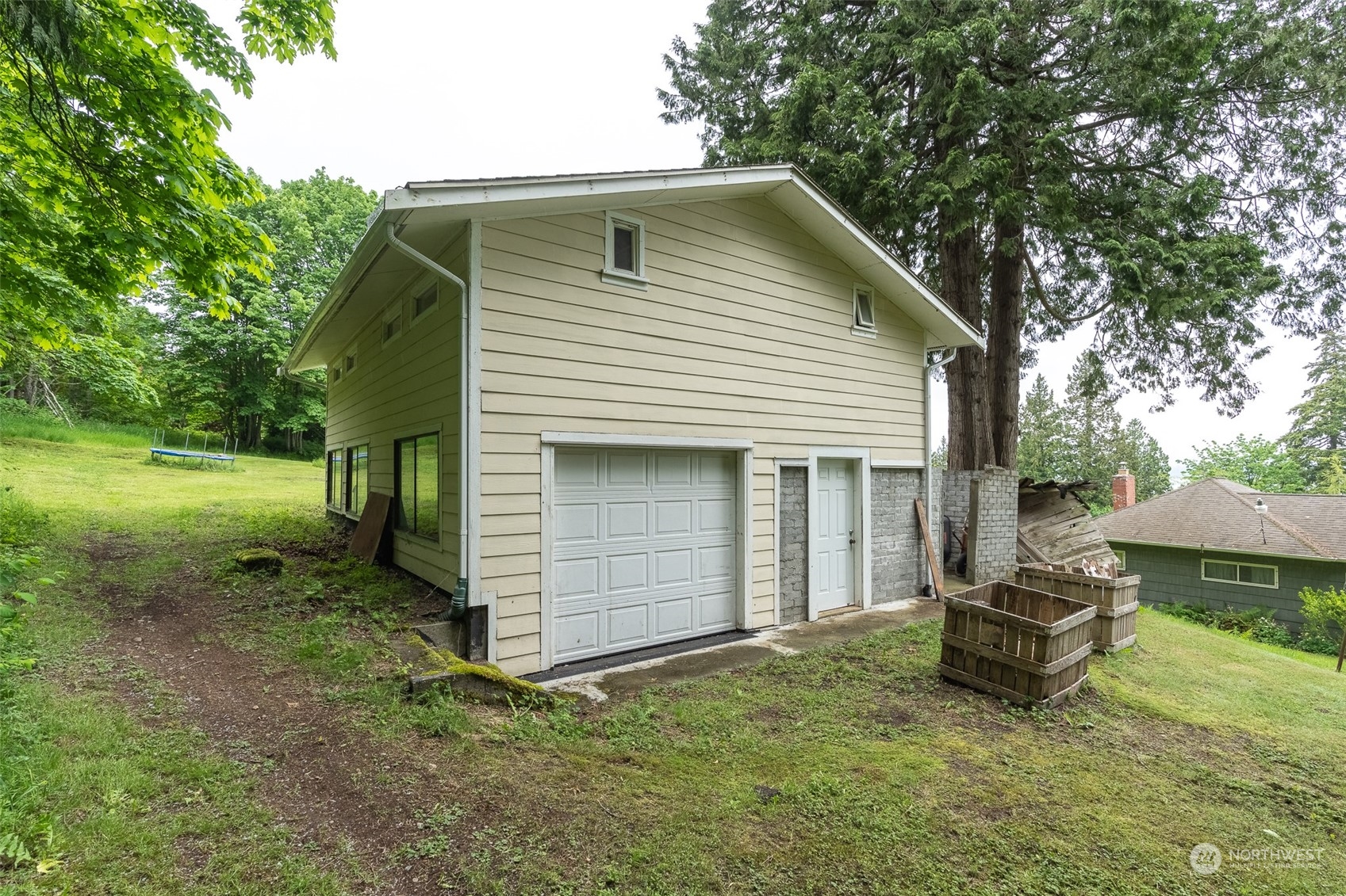 5273 Drayton Harbor Road Blaine, WA 98230 - Photo 19 of 33 a backyard of a house with a garden and barbeque oven