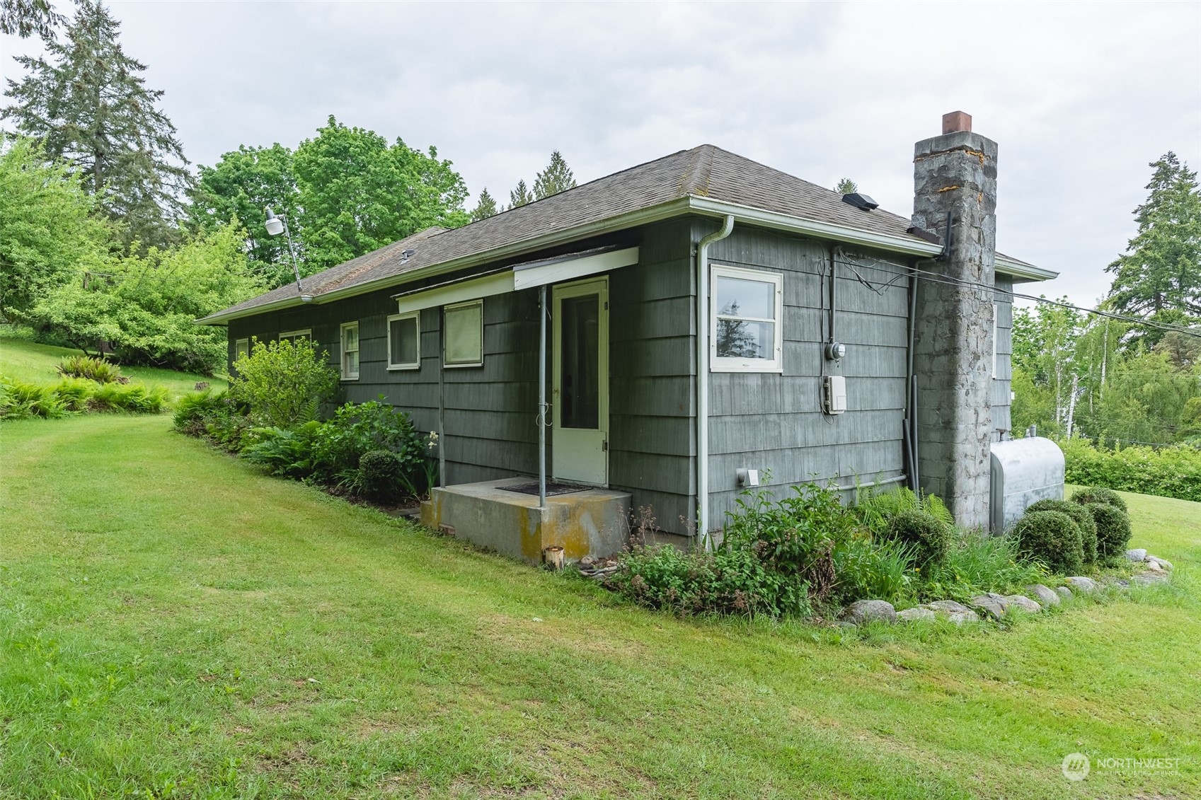 5273 Drayton Harbor Road Blaine, WA 98230 - Photo 28 of 33 a front view of a house with a garden